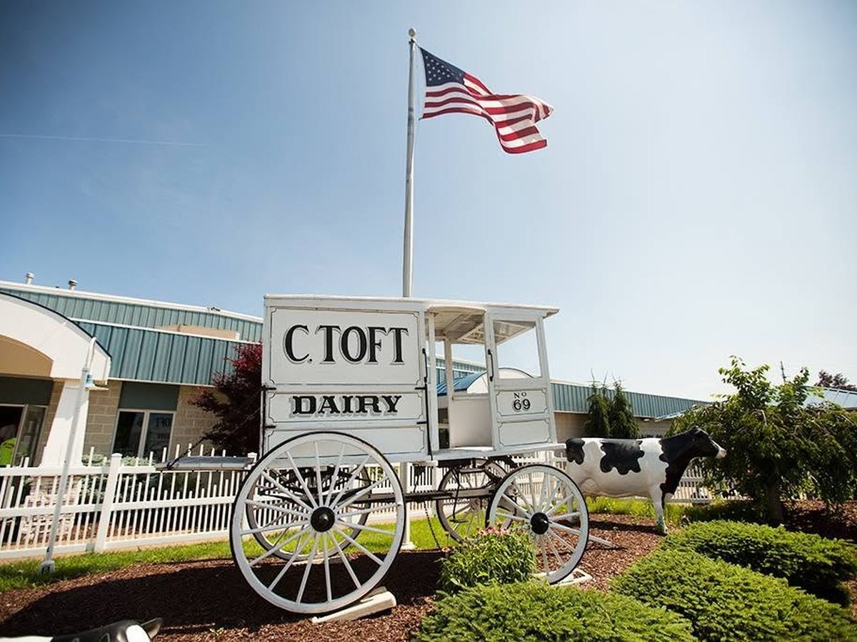 Toft Dairy plant exterior with historic C. Toft Dairy wagon