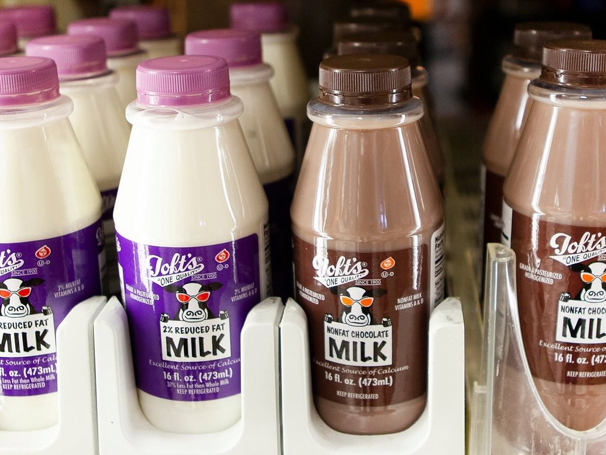 Toft milk bottles on a retail cooler shelf